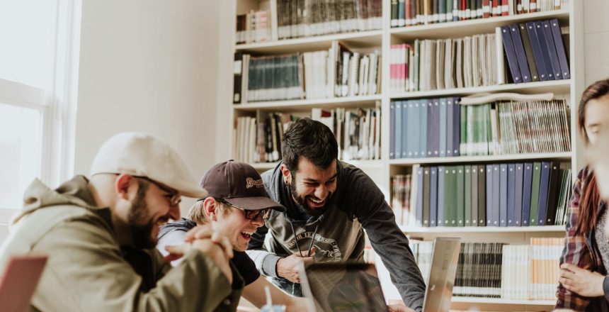 college students grouped together in a library, college students studying