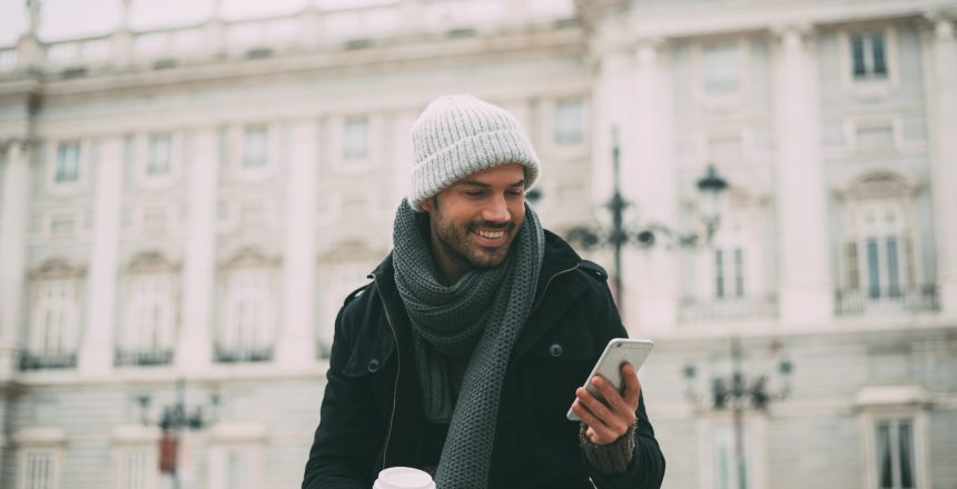 Young,Blonde,Man,On,The,Mobile,Phone,And,Drinking,Coffee