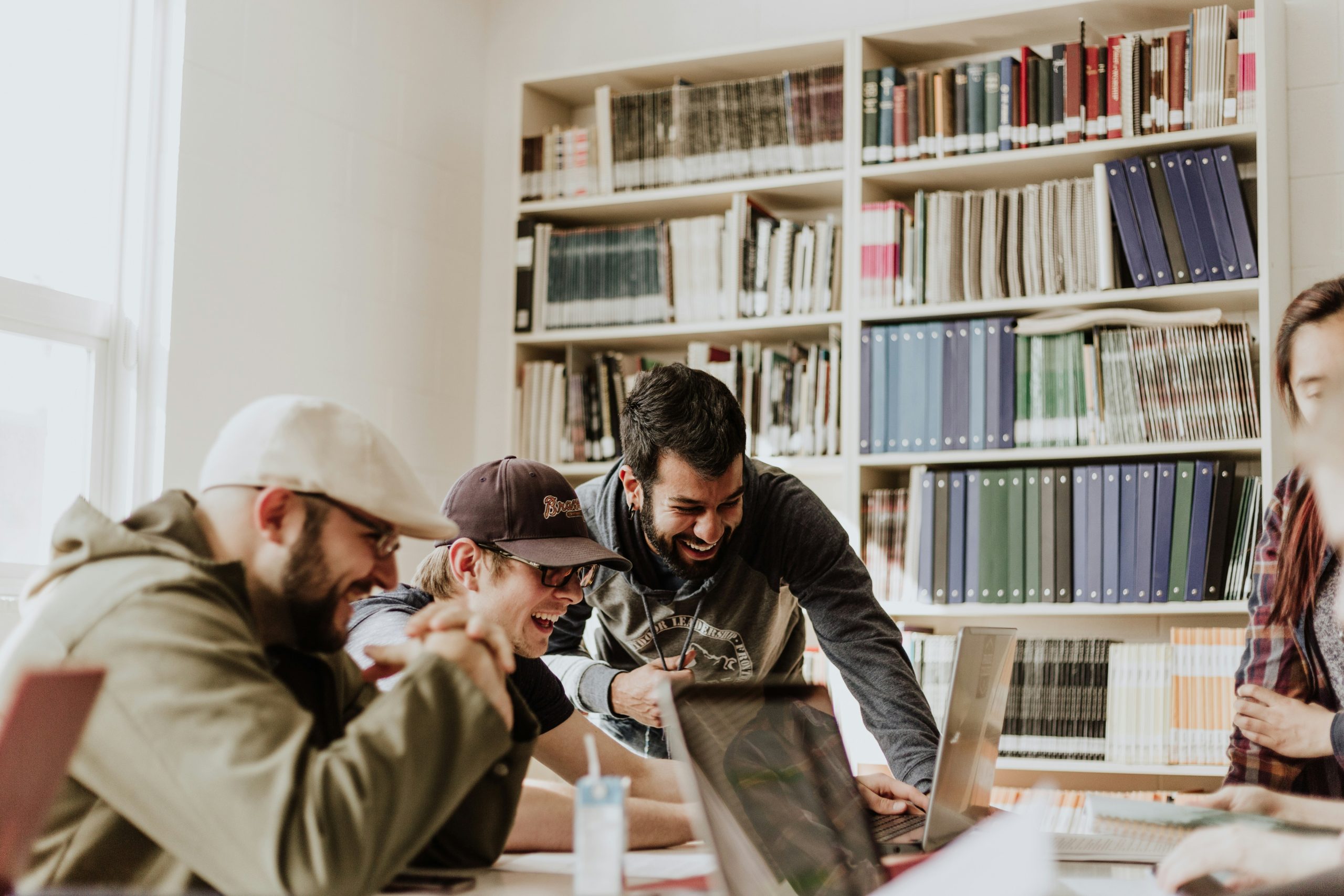 college students grouped together in a library, college students studying