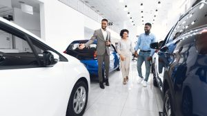 couple shopping for a car, car shoppers inside an auto dealership